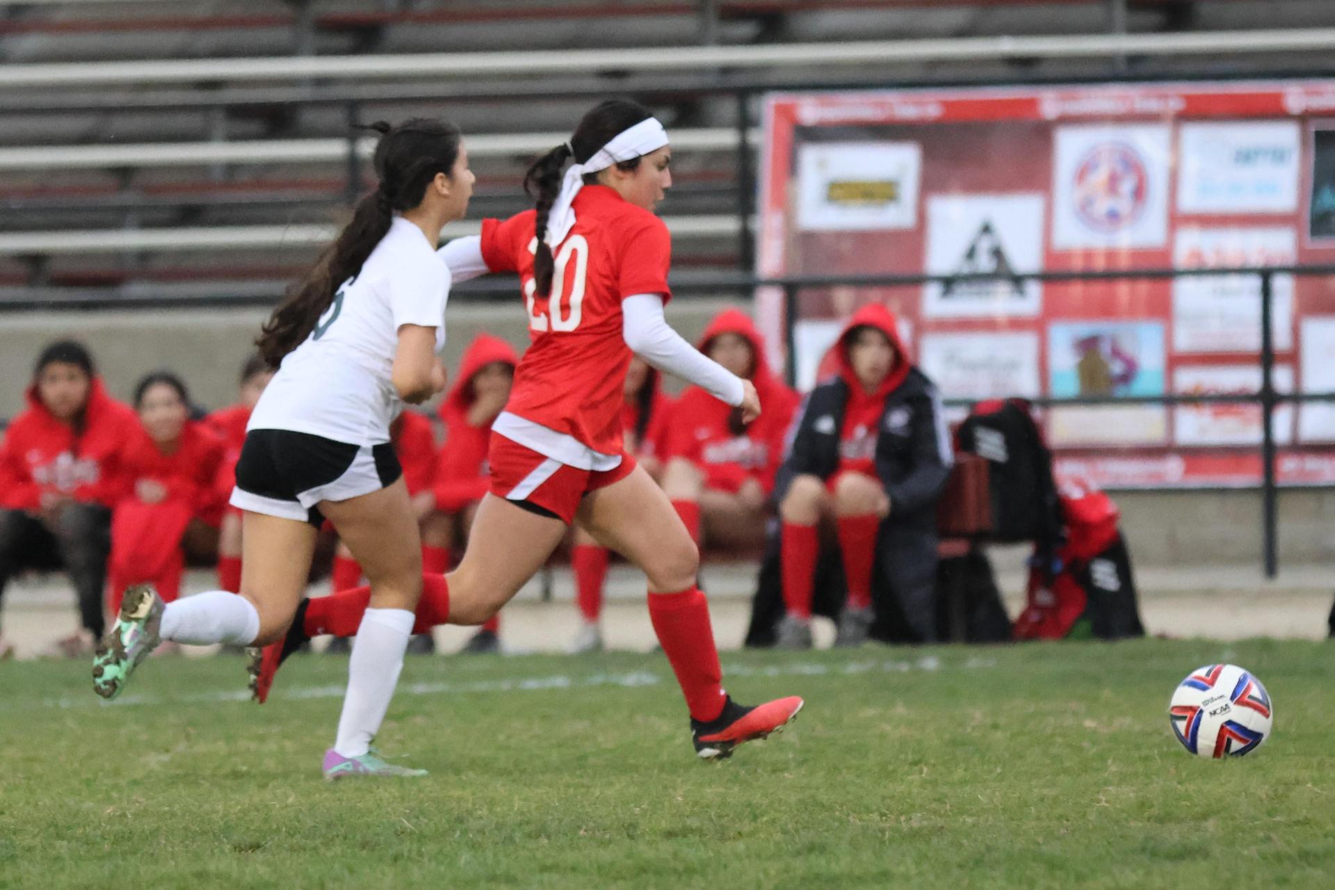 Junior varsity girls playing soccer against liberty