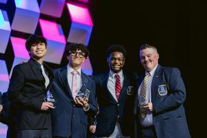 Smiling group of students, some with awards