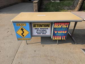 A table with signs promoting positive attitudes and respect.