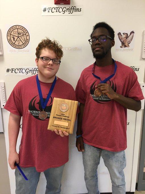 Students holding their award