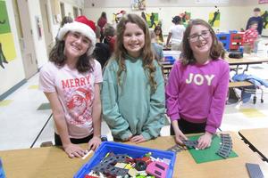 Leah Yeager, Emma Yeager, and Helen Nutt work together during Lego club