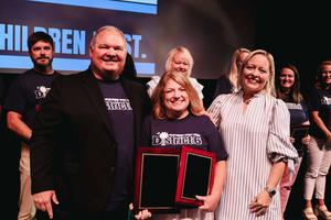 A photo of our District Teacher of the Year with Superintendent and Board Chairwoman