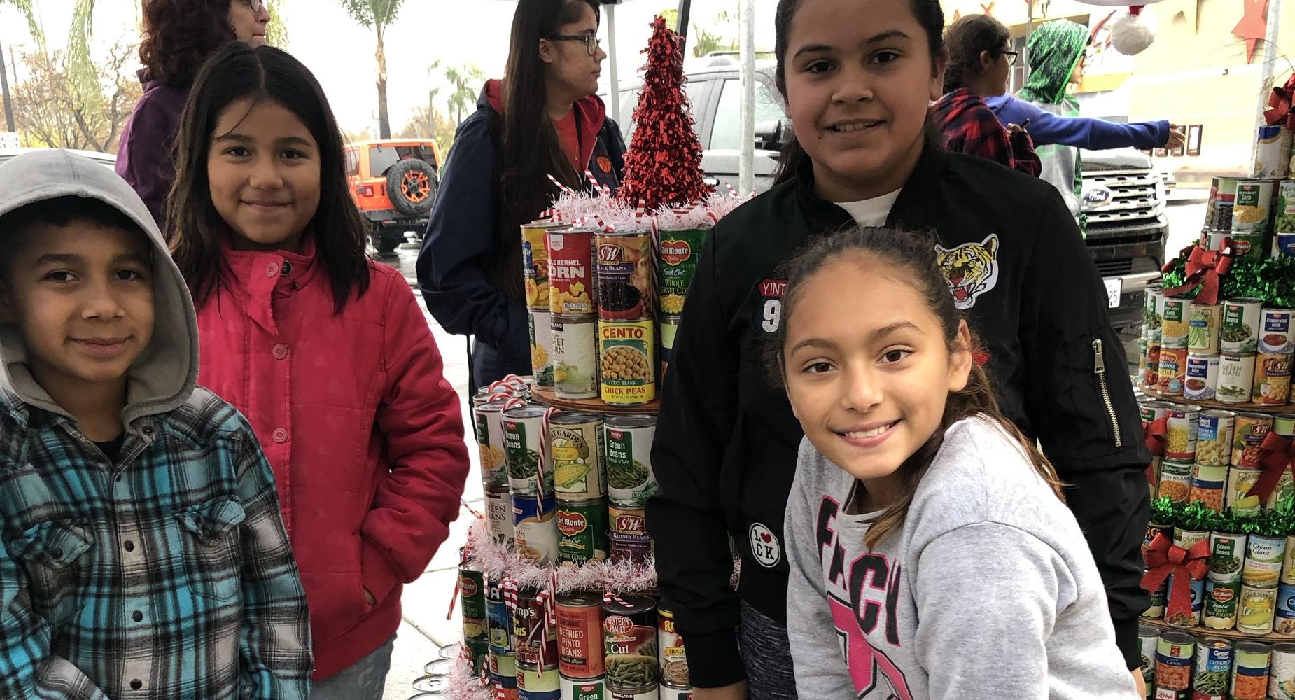 Some CHOICES students make a canned food Christmas Tree.