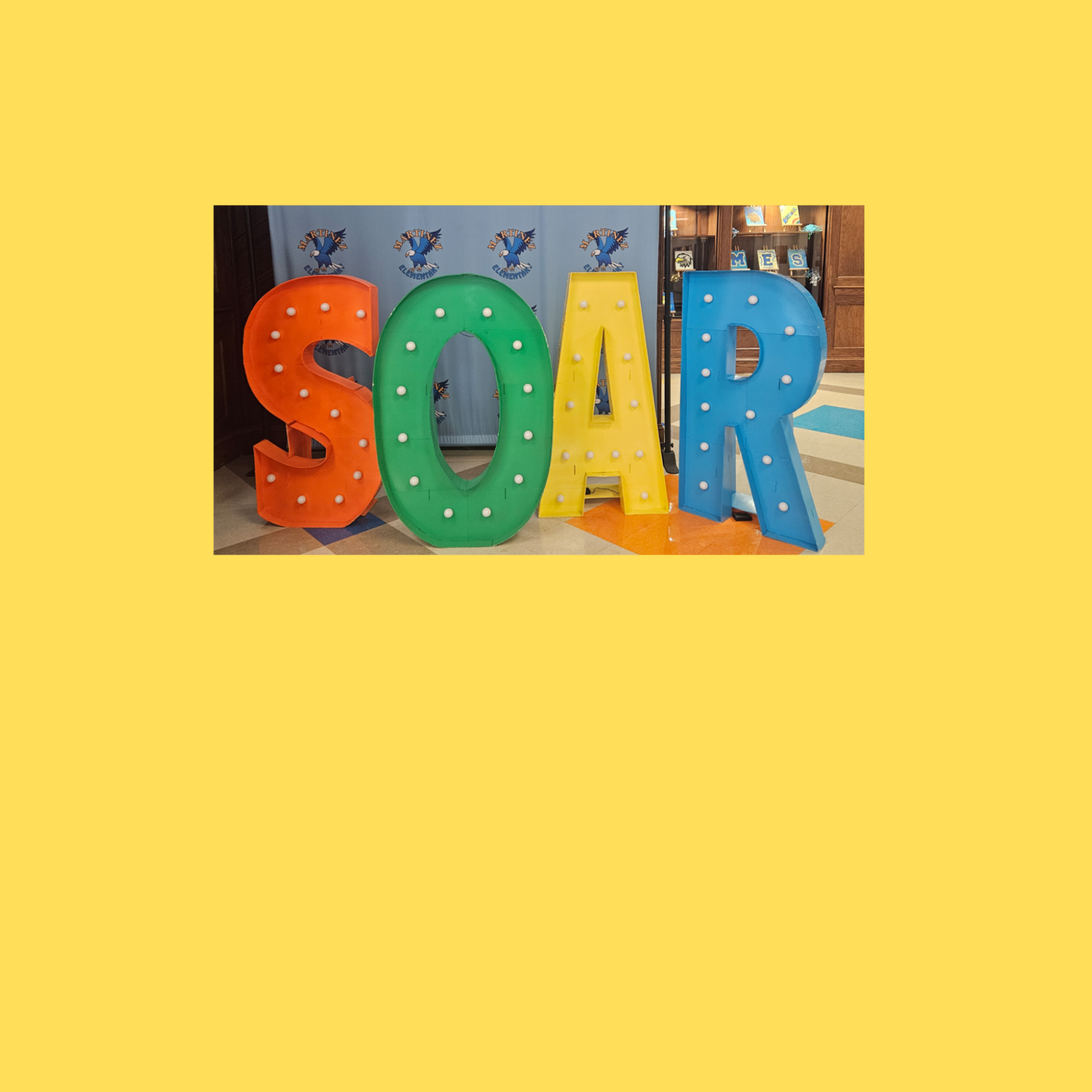 Colorful letters spelling 'SOAR' in front of a blue backdrop.