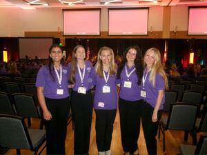 Five smiling teen girls in purple polo shirts on FL Congress Floor