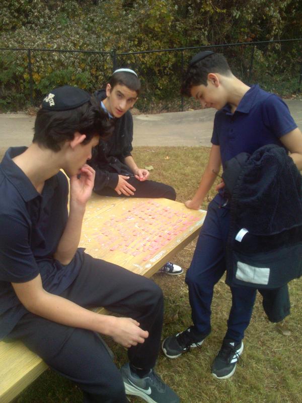 Eighth grade boys taking stock of the words they found in the field.