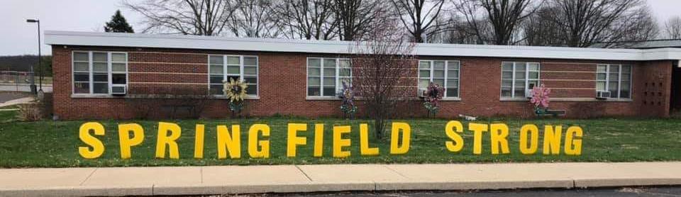  The front of the Springfield school with an outdoor sign reading "Springfield Strong"