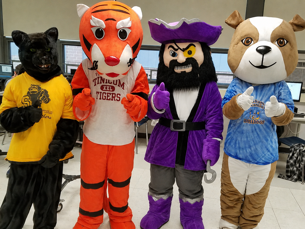 All four mascots (Pawblo, Stripes, Pirate and Spike) standing together giving the thumbs-up sign.