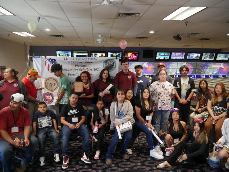 A group photo of youth at a bowling alley.