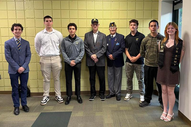 the students who are entering the military stand together for recognition at the May 11 board meeting