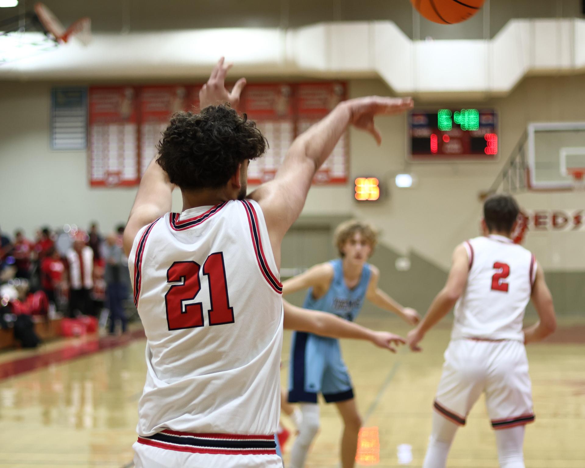 Varsity boys playing basketball against yosemite