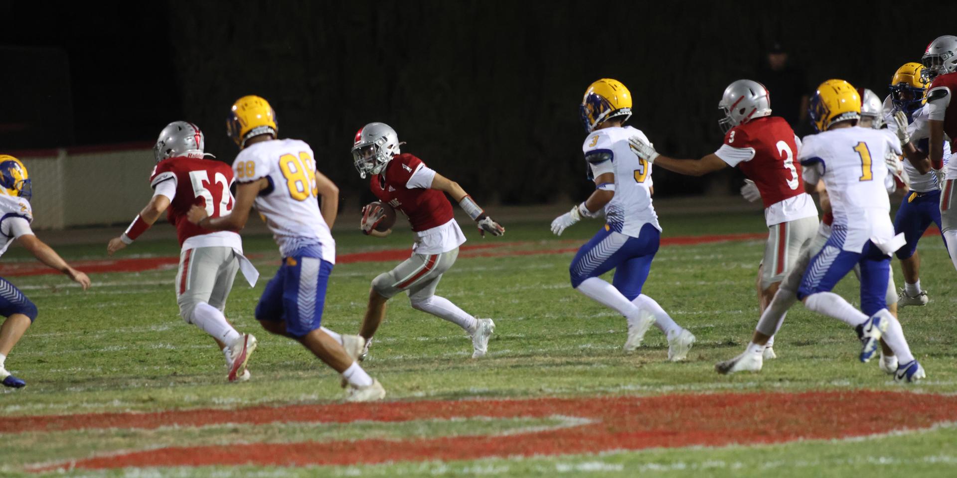 Varsity football players in action against Parlier 144