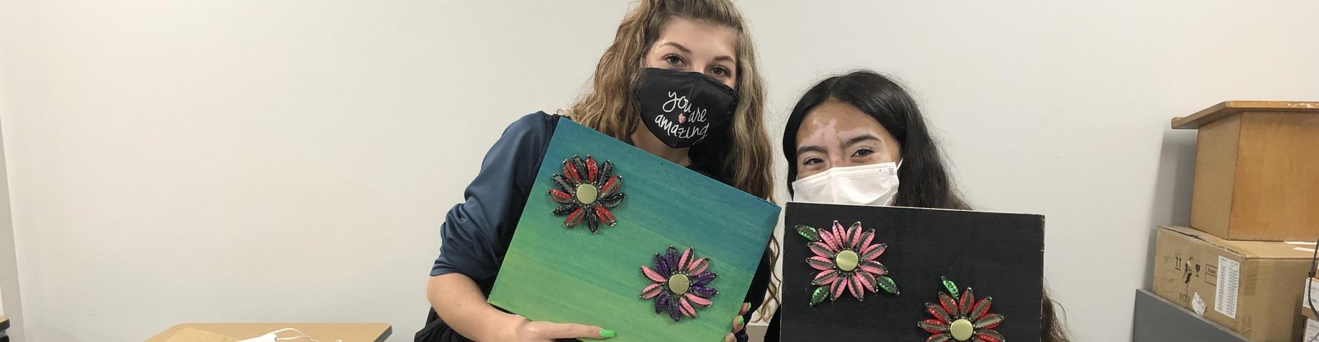 MHS LINKS students showing off their art work using colored bottle caps.