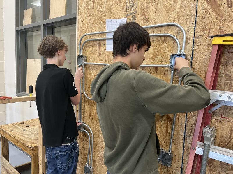Students work in the electrical program