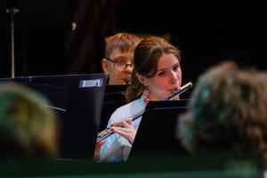 A band member plays the flute