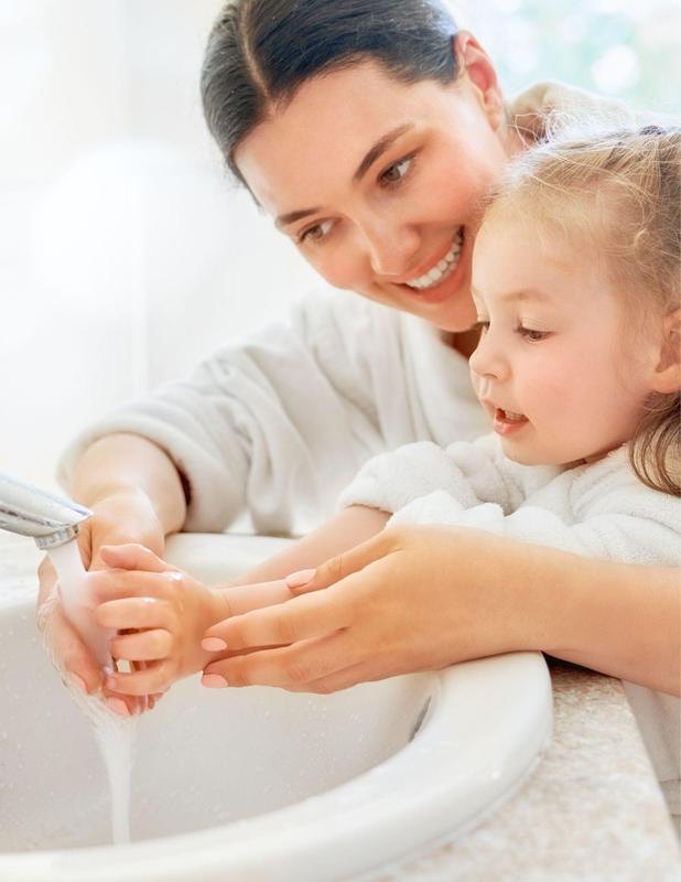 mother washing hands for daughter