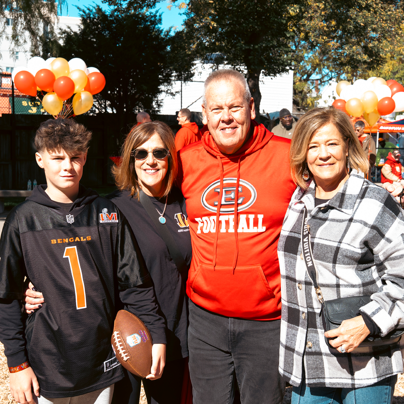 Three adults and one teenager standing, posed photo