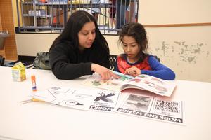 A parent reads with her child