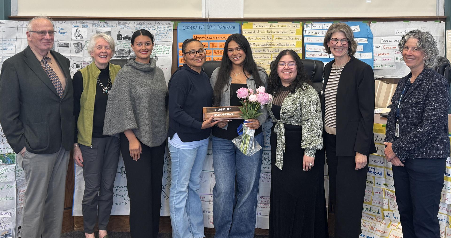 School board members posing for photo with student representative