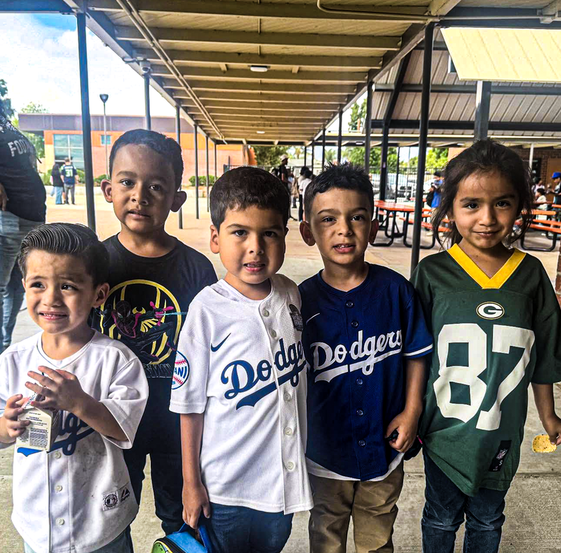 about five students wear sports team clothing in support for attendance