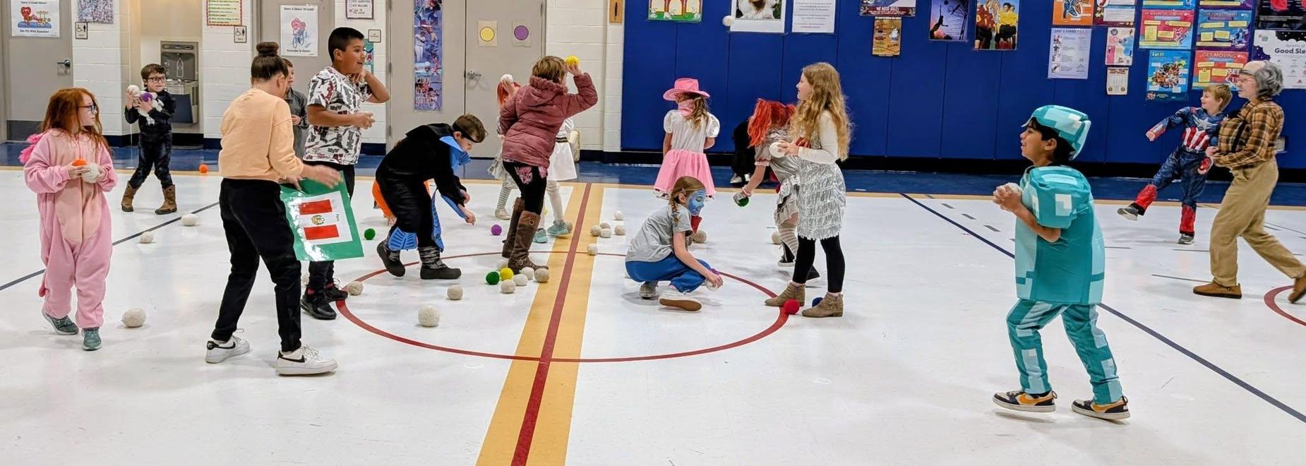 Children playing games and engaging in activities in a colorful gymnasium.