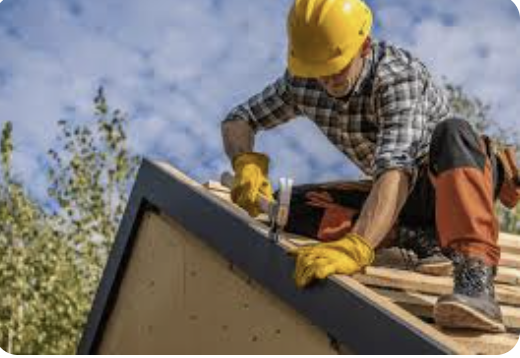 Photograph of a roofer nailing a tile on a roof