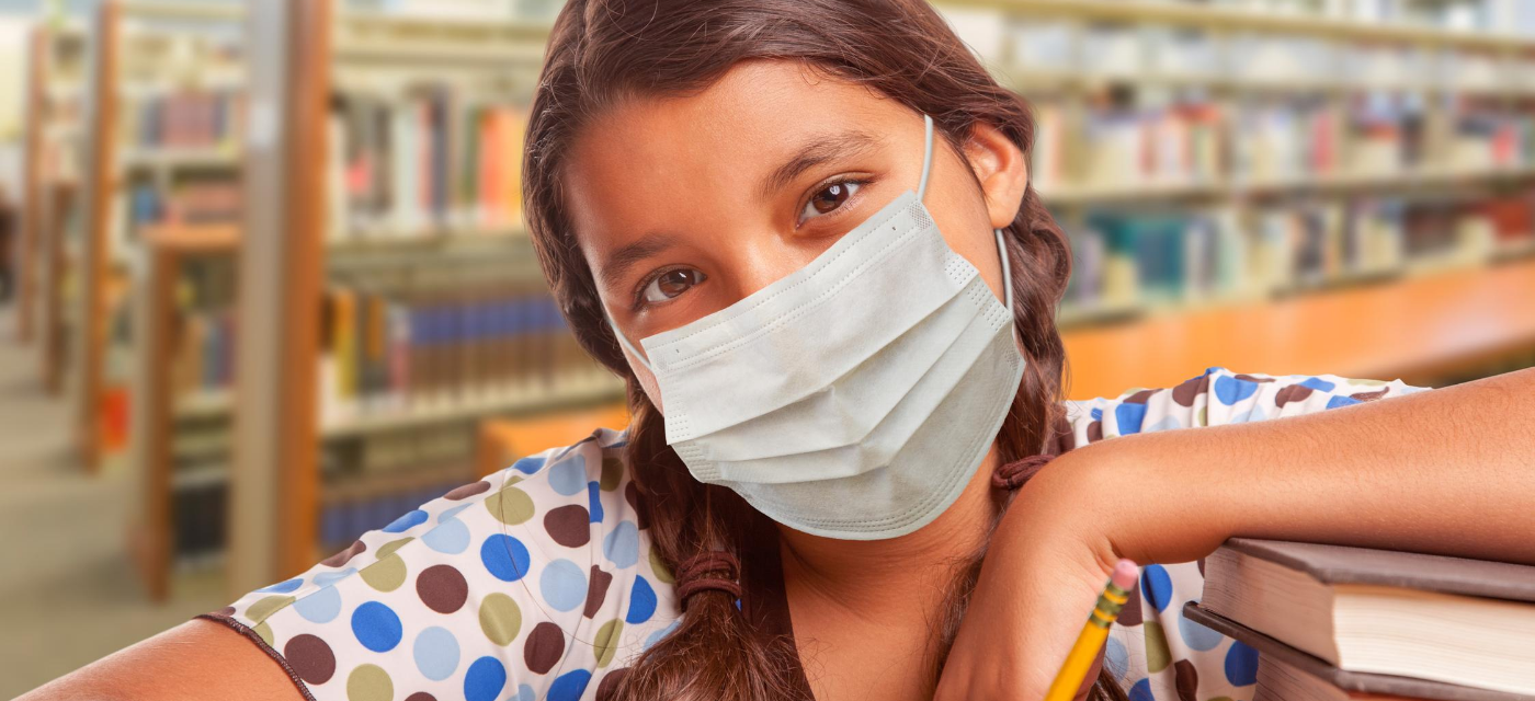girl wearing face mask in library