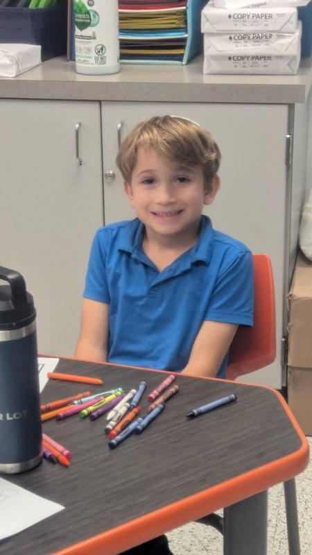 A first grade boy reacts to a tense part in the story.