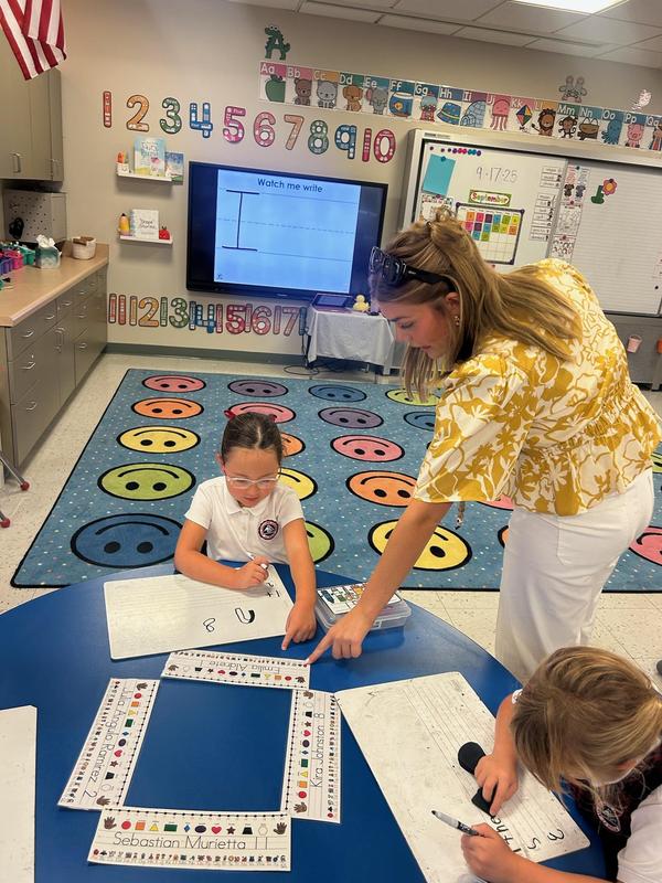 teacher working with a student in Kindergarten