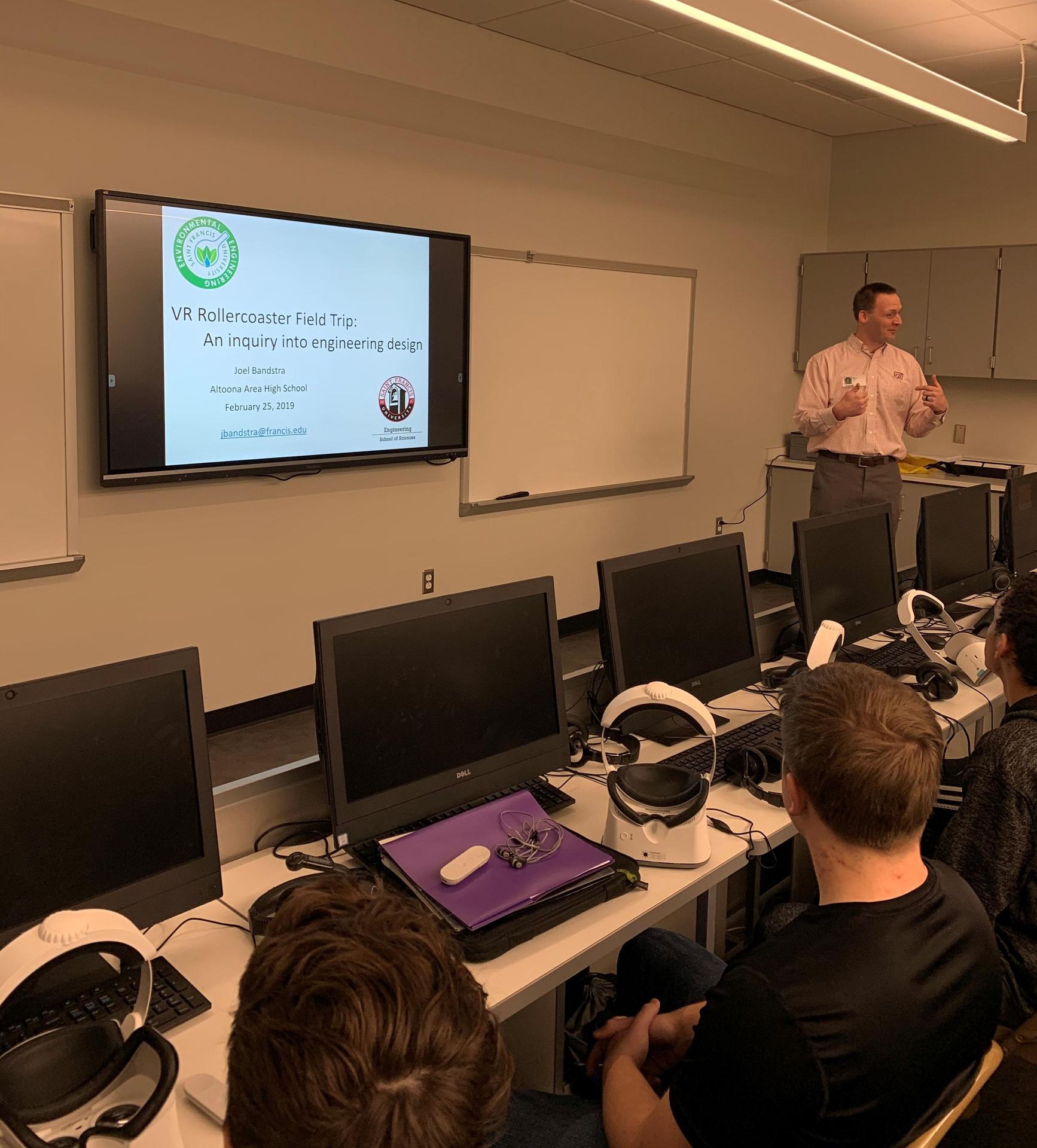 Dr. Joel Bandstra, Saint Francis Professor, guest teaches Mr. Borst's physics class on the nuances of designing roller coasters for their projects at the AAHS Library.