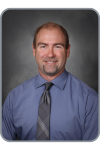 Jason d'Autremont, a man in a blue shirt and tie.