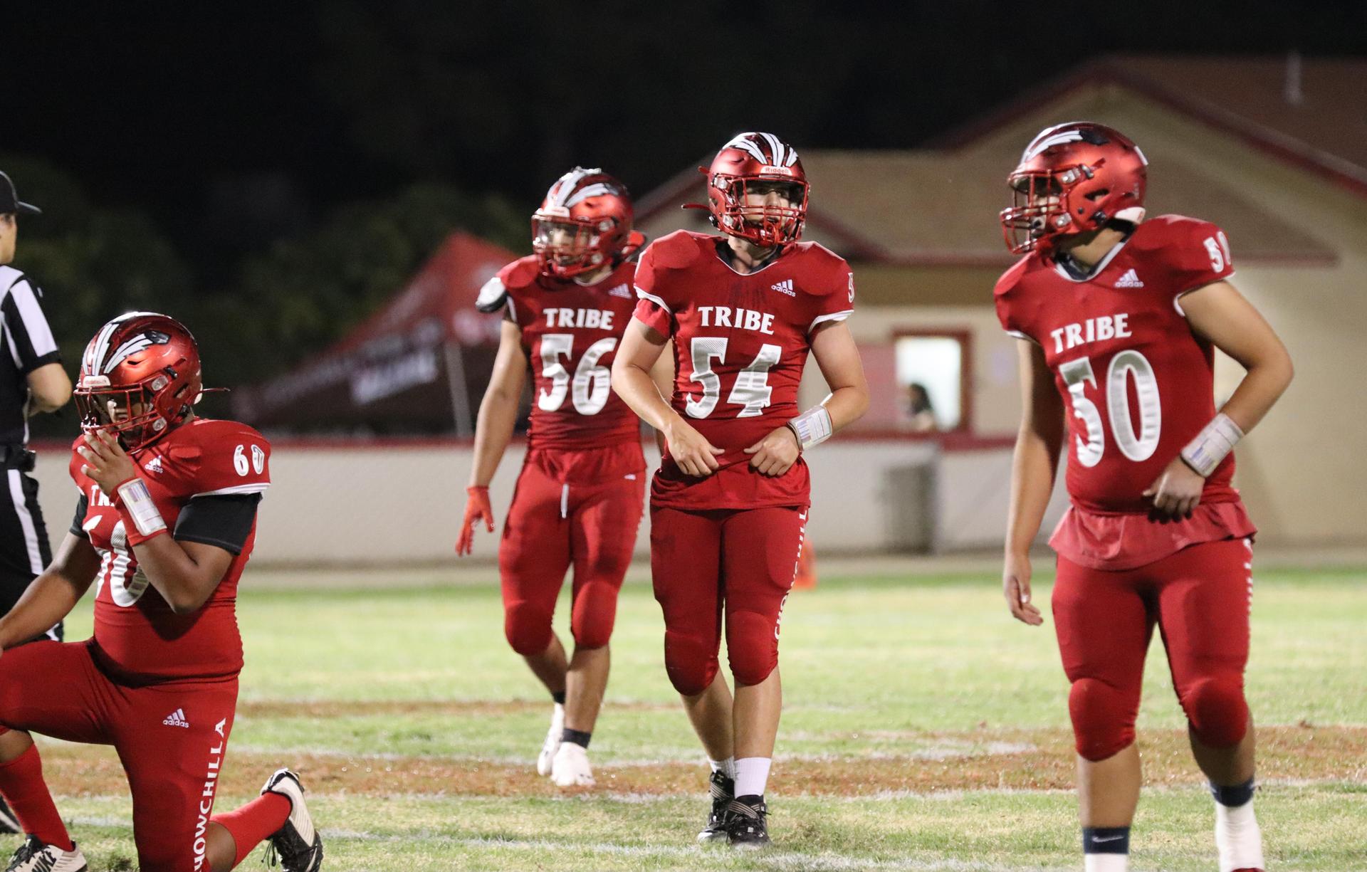 varsity football players in action against Riverdale