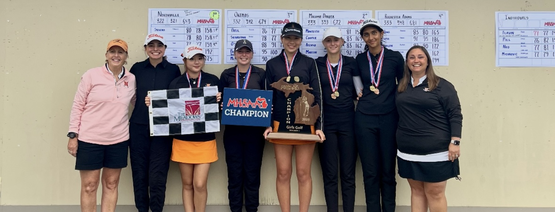 Group photo of NHS girls golf team holding the state championship trophy.