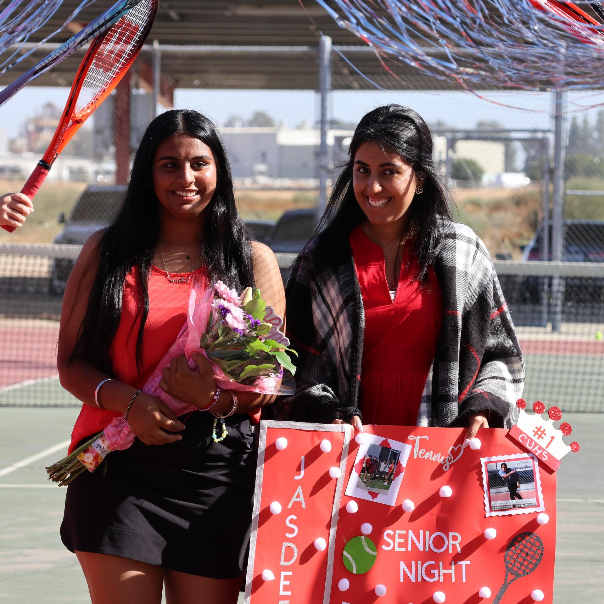 tennis players, family, and staff celebrating senior night