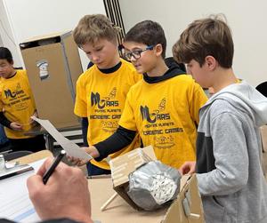 three students doing a presentation