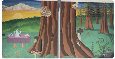 Picture of the painted mural at Coast High, trees, a tea party and some forest critters