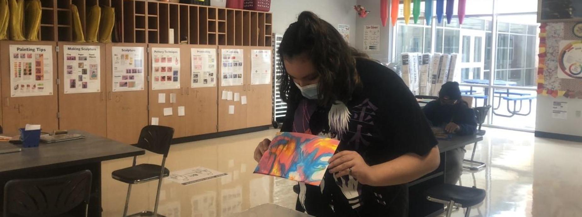 Student showing art projects