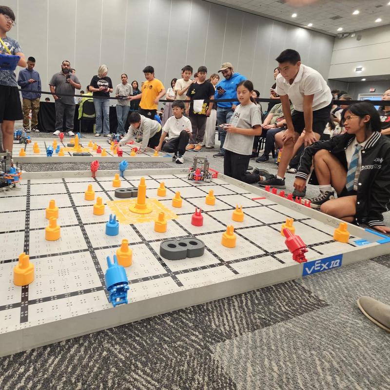 kids on the floor with robotics tools