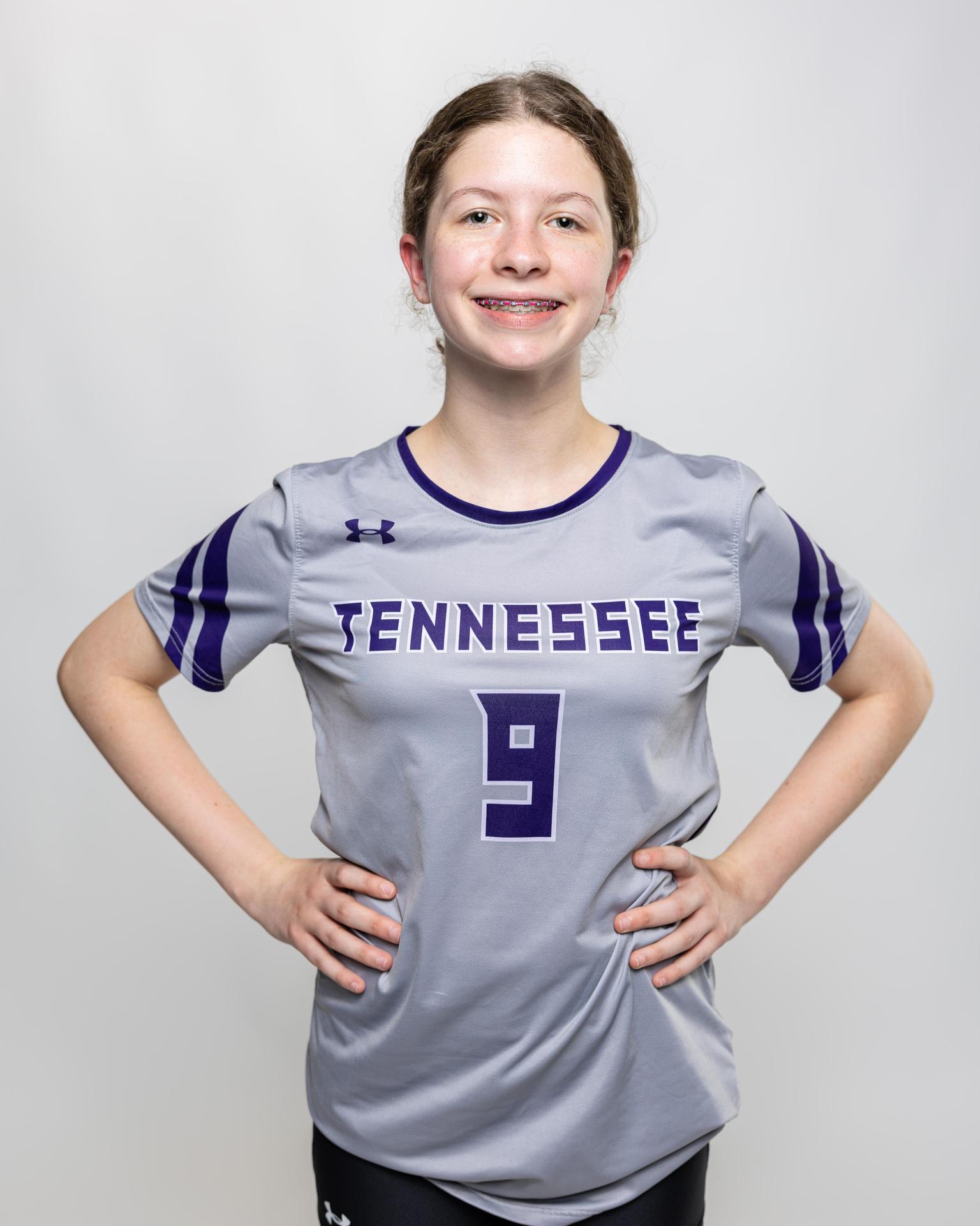 number 9 female volleyball player posing