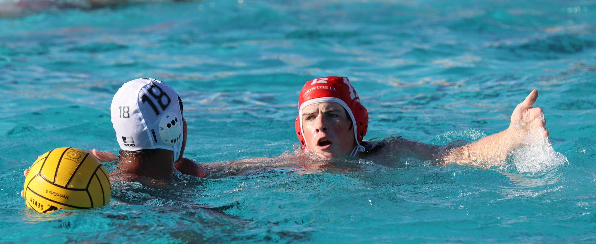 boys water polo players in action against hoover