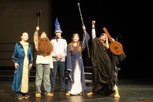 Play members act out a scene as they rehearse for the show.