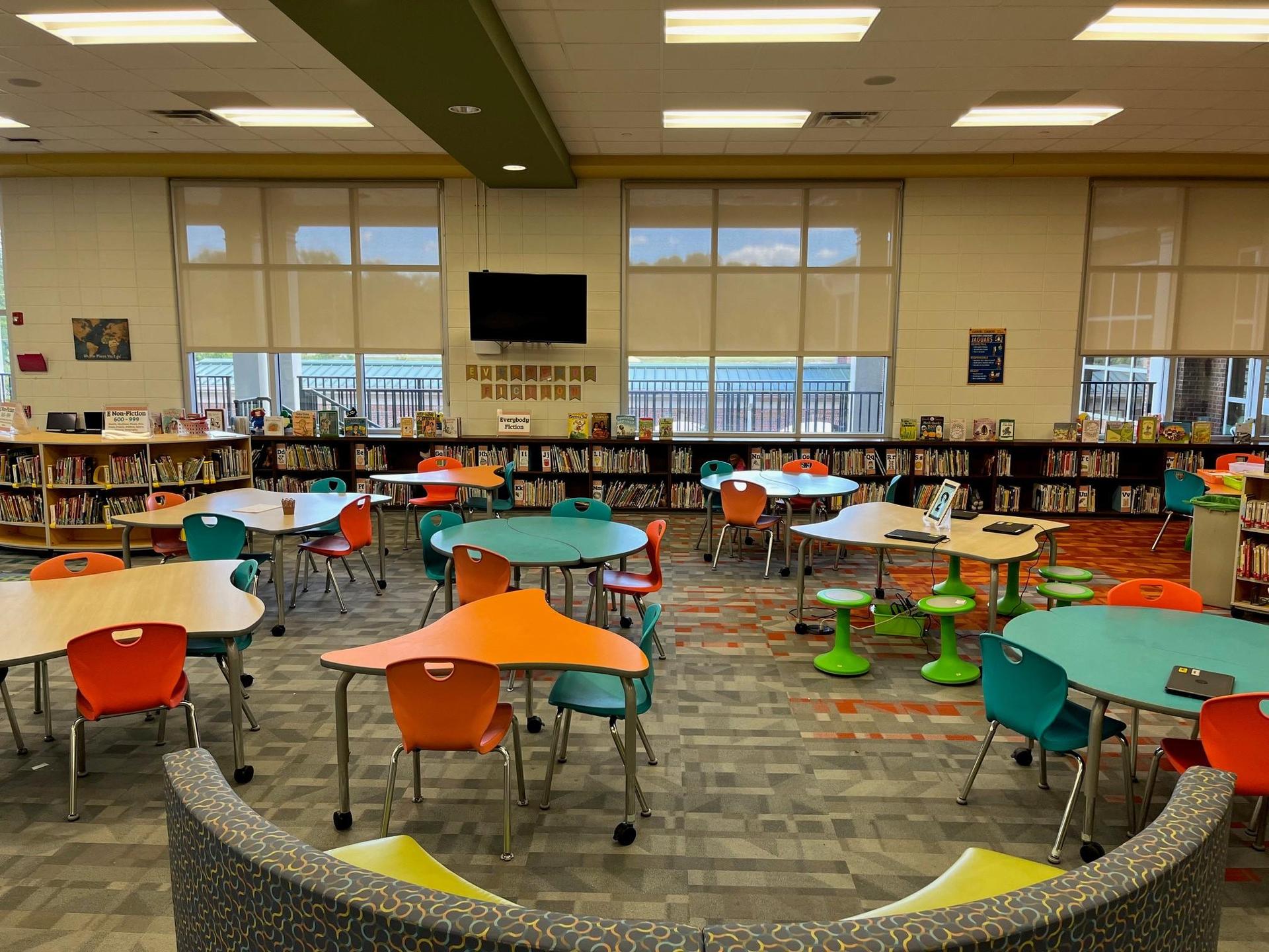 Grovetown Learning Commons space including tables, chairs, and shelves of books.