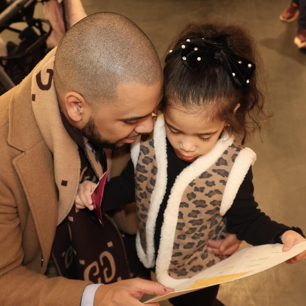 Adult and child looking at art together