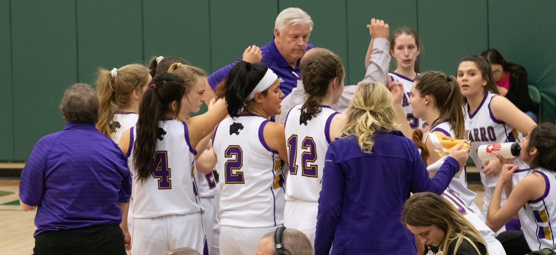 Girls huddled during basketball game