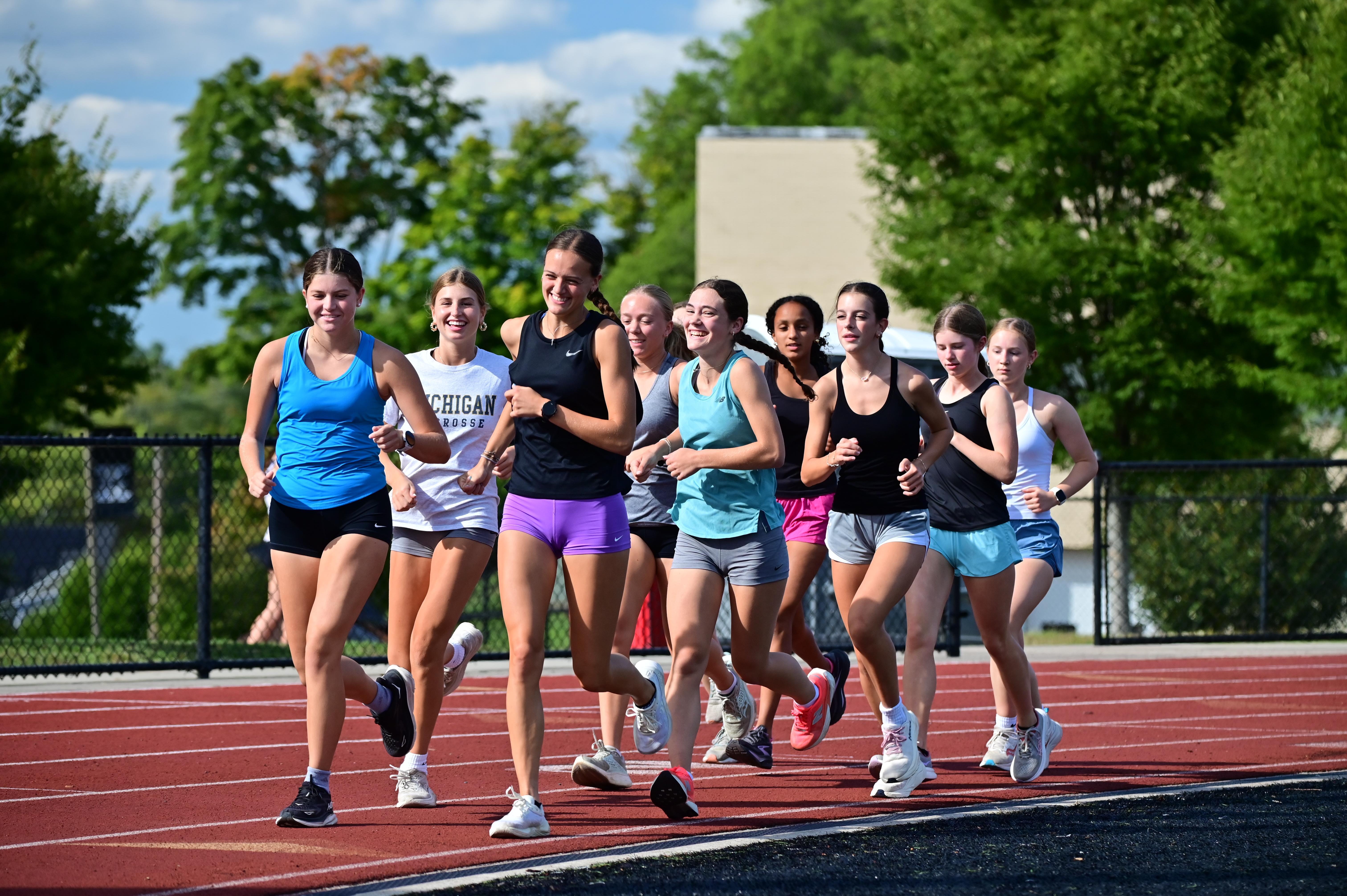 The Mercy Cross Country team enjoys a warm-up run together