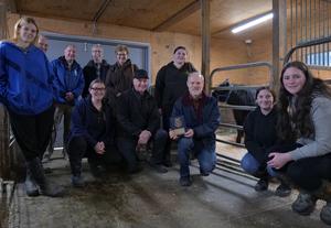 The rainvilles, principal, ag department teachers and students pose with a plaque of appreciation