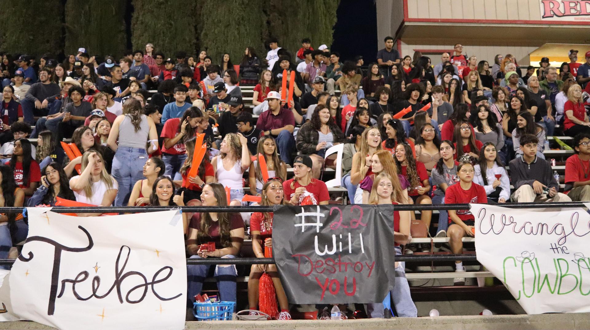 students, staff, and community members enjoying Friday night at the football game