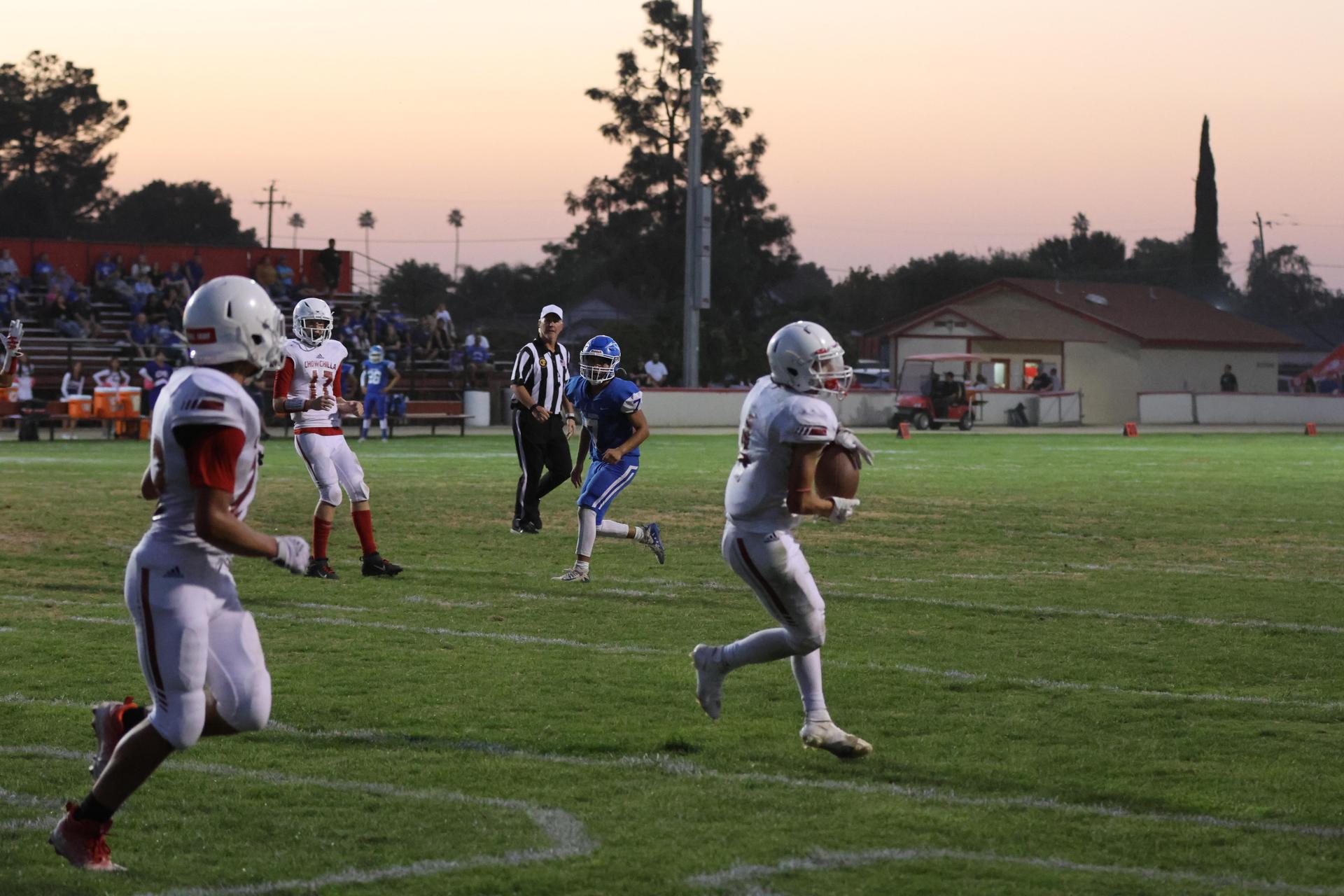 Junior Varsity football players in action against Caruthers