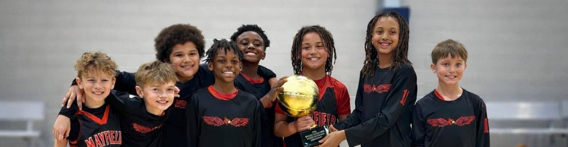 4th grade boys basketball team holds their trophy