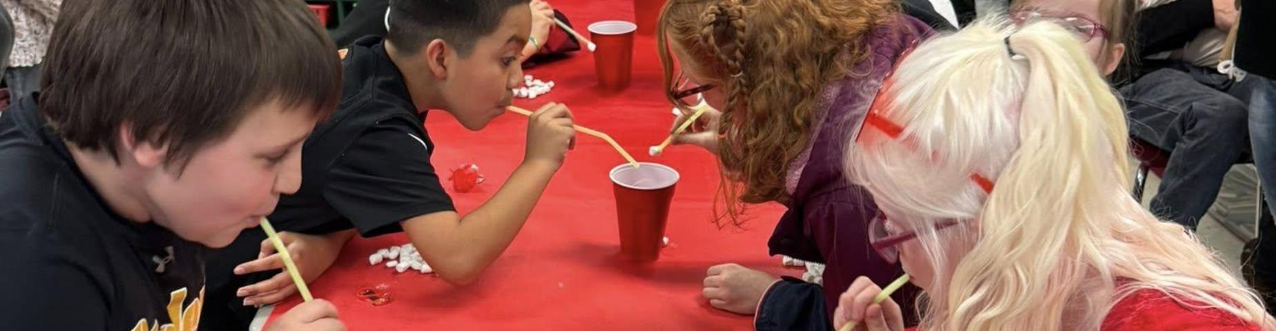 MES students playing a game at the Valentines Day party.